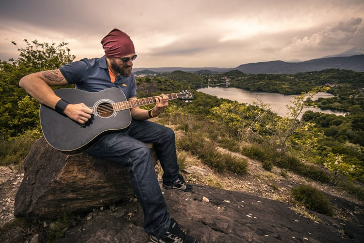 Guitarist using a capo