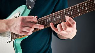 Guitarist with a funny expression while playing