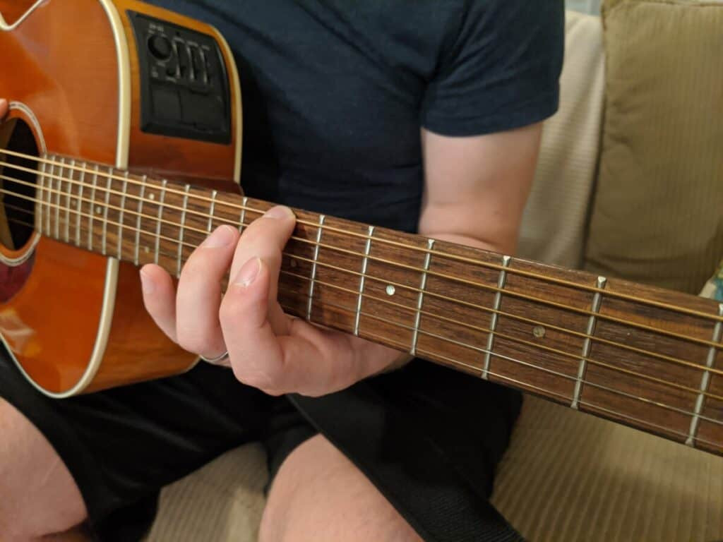 Sliding finger from 5th to 7th fret while maintaining pressure