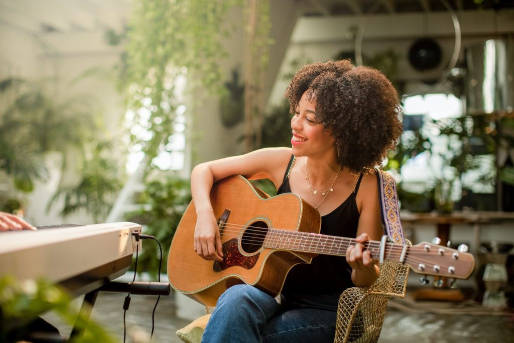 Woman playing acoustic guitar