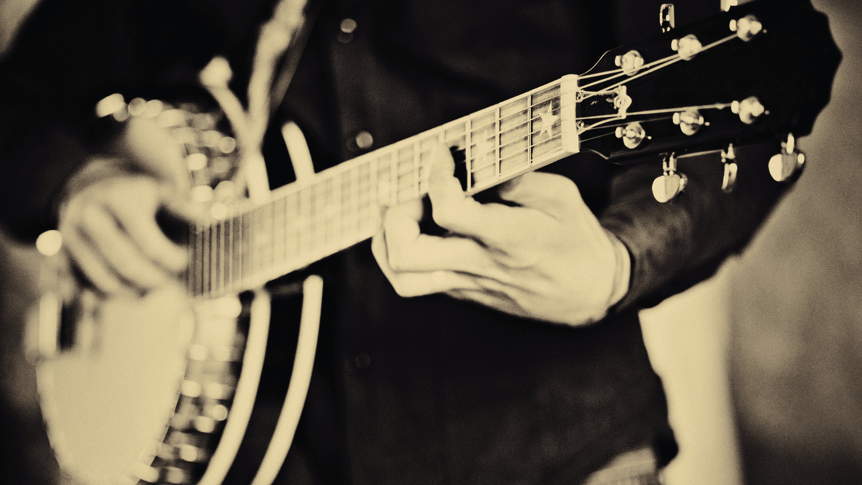 Steve Martin playing banjo, demonstrating his mastery of the instrument and dedication to bluegrass music