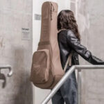 Guitar case for back carry showcasing padded straps and durable material