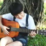 Beginner guitar player practicing basic chords