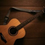 Close up of guitar frets and strings, highlighting the complexities of chord shapes