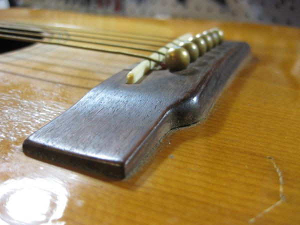 Bellied guitar top showing a bulge behind the bridge
