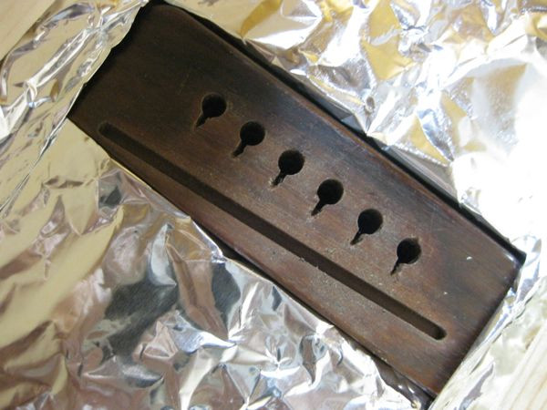 Guitar with a heat shield and lamp for bridge removal