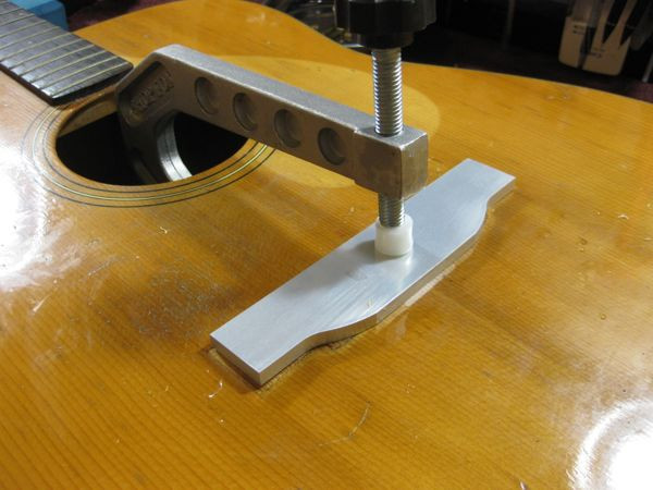 Close-up of the cauls clamped onto the guitar top