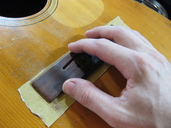 Gluing the bridge back onto the guitar top