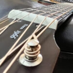 A guitar neck, seen from the headstock down on the bass side.