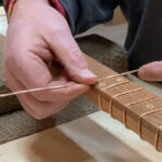 Guitar frets being polished