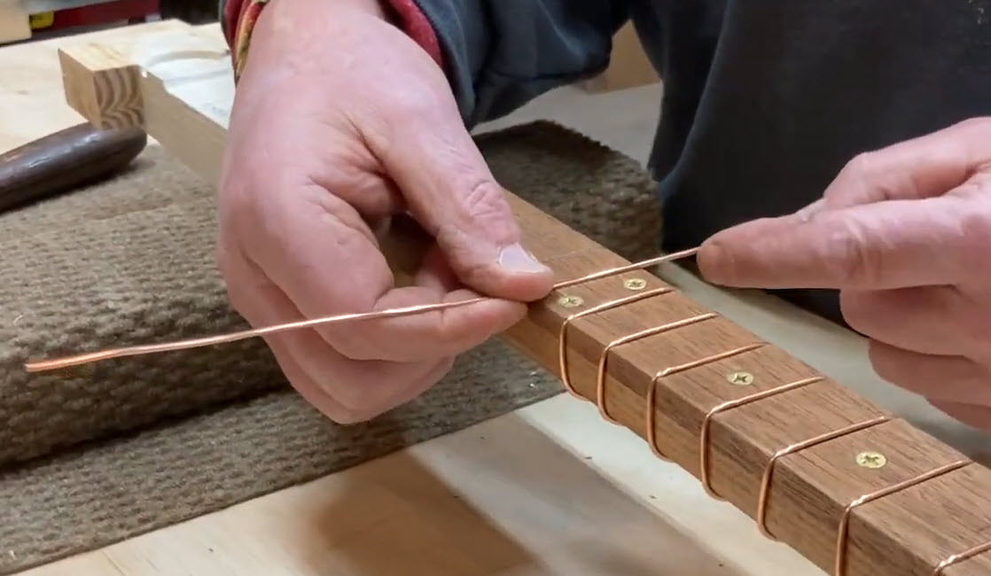 Guitar frets being polished