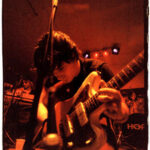 Jason Sebastian Russo playing guitar on stage at South by Southwest