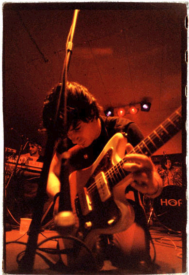 Jason Sebastian Russo playing guitar on stage at South by Southwest