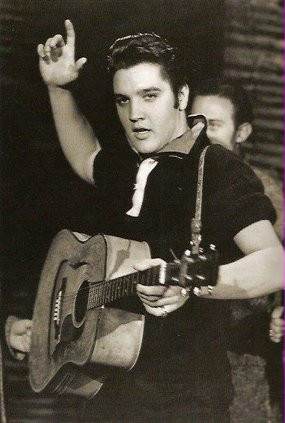 Elvis Presley on the Ed Sullivan Show with a guitar