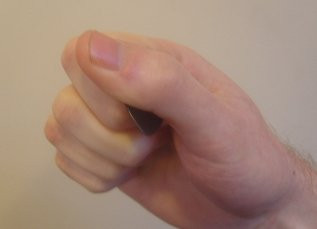 Close up of the fist method demonstrating a secure guitar pick grip