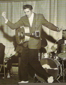 Elvis Presley performing on Hayride with his guitar