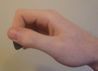 Guitar pick holding technique