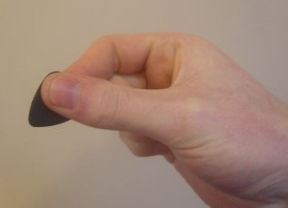 Guitar pick pinched holding technique