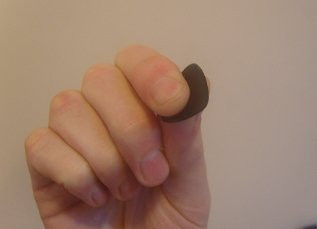 Detailed view of the pinch method for holding a guitar pick